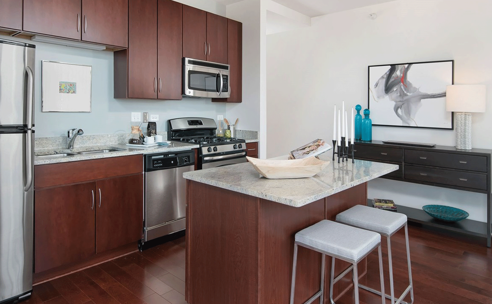 Modern kitchen featuring stainless steel appliances and gas range stove in luxury Chicago apartment building